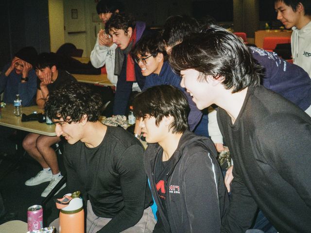 Brothers gathered around a table during a game night