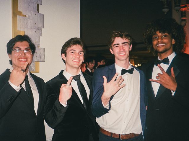Four brothers in formalwear posing together