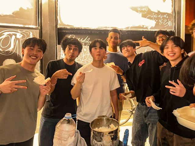 Friends laughing together around a kitchen counter