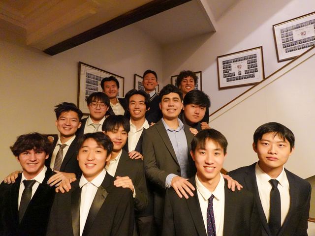 Brothers dressed formally on the composite-lined staircase inside 229