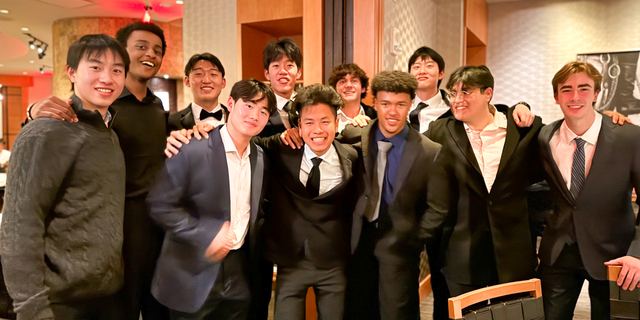 Brothers dressed in tuxedos and suits gathered inside the house