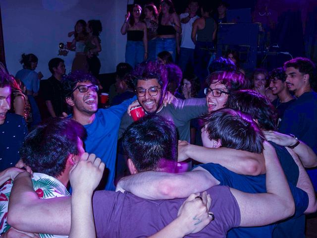 Brothers sharing a group hug on the dance floor