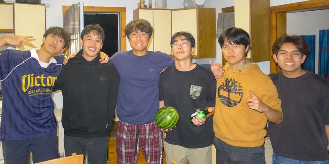 Brothers posing together in pajamas inside the house