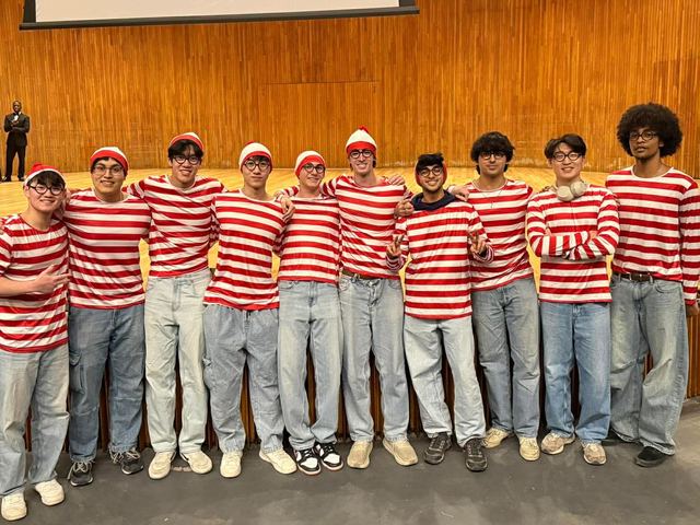 Brothers lined up in matching red-and-white striped costumes